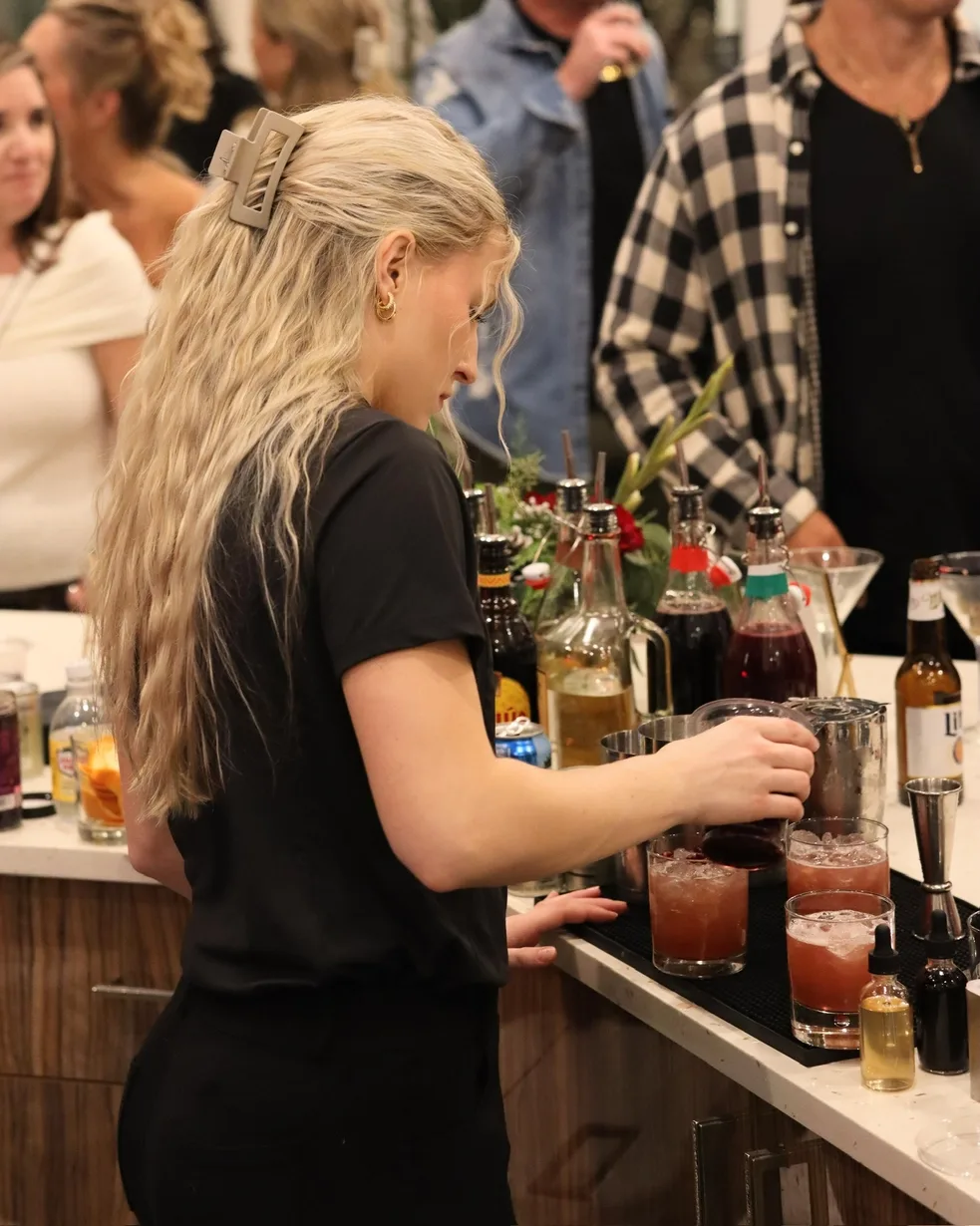 TB Mixology bartender pouring cocktails at a private event