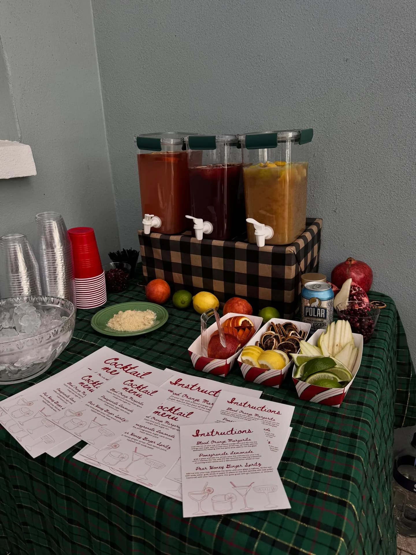 Batch cocktail dispensers with printed menus and fresh garnishes