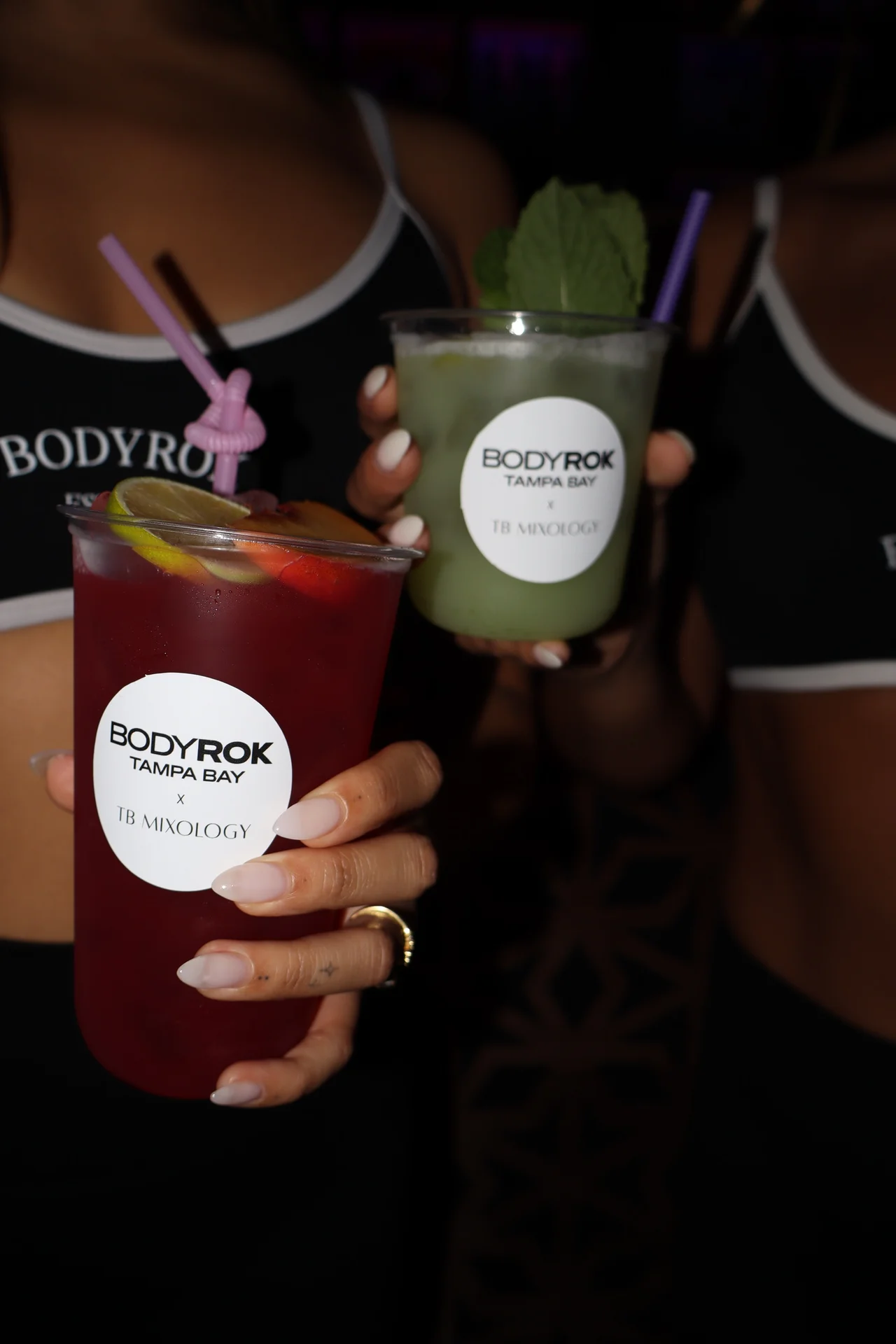 Co-branded BODYROK Tampa Bay and TB Mixology cocktail cups held up close