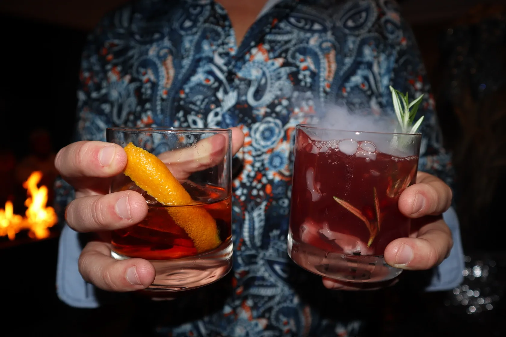 Old fashioned and berry cocktail by the fireside at Christmas party