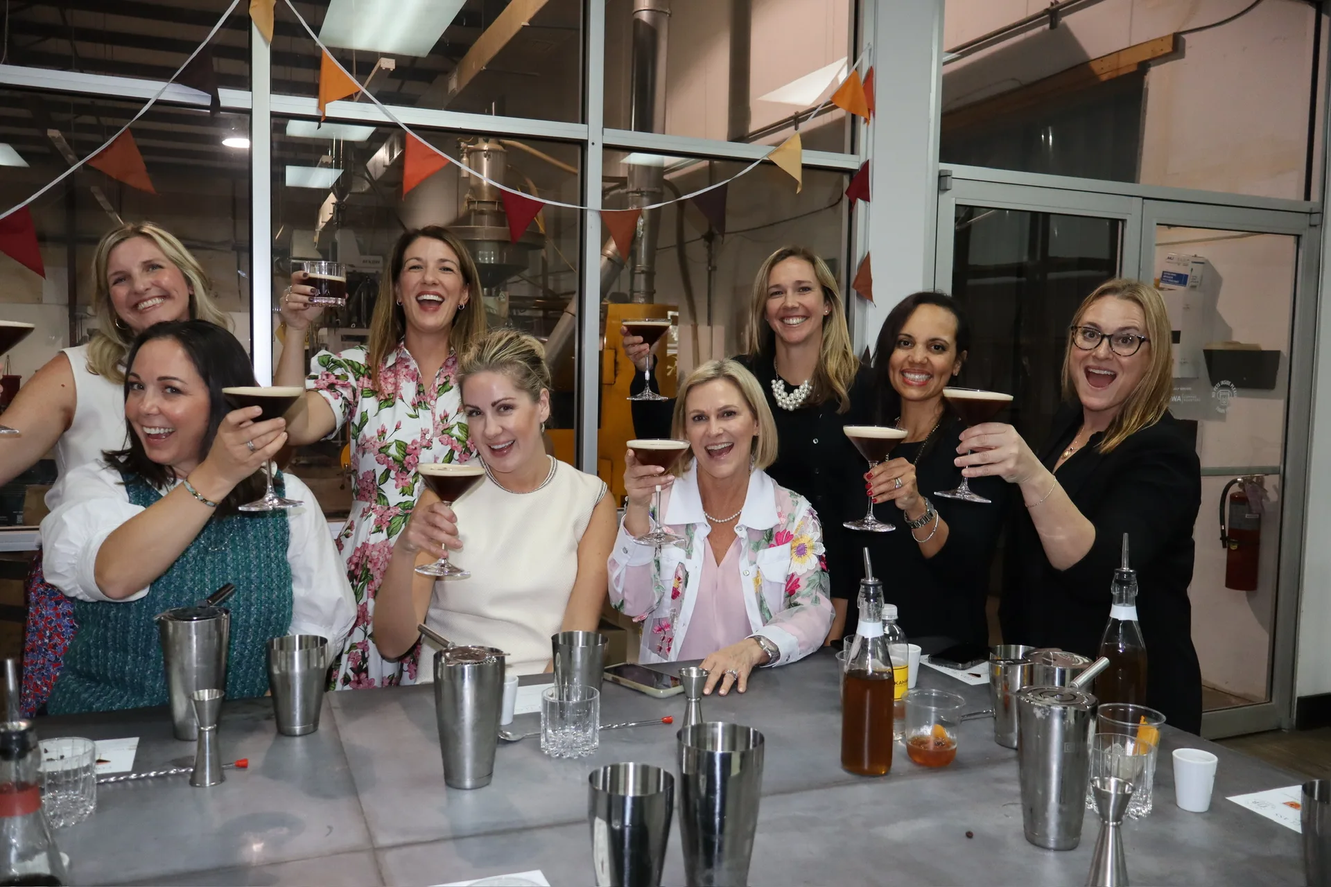 Group raising espresso martinis for cheers at Kawha cocktail class