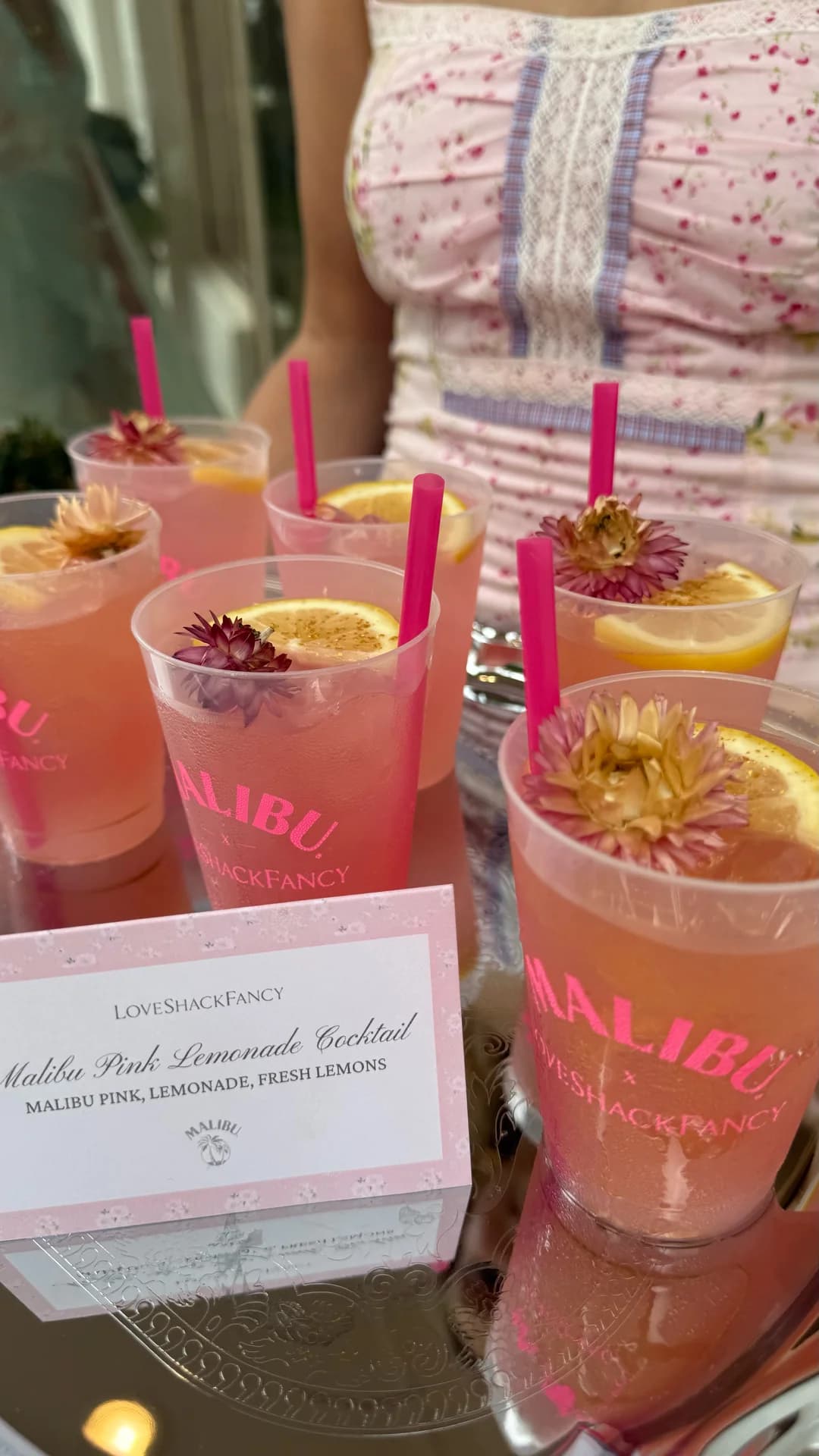 Malibu Pink Lemonade cocktails garnished with dried flowers in branded cups