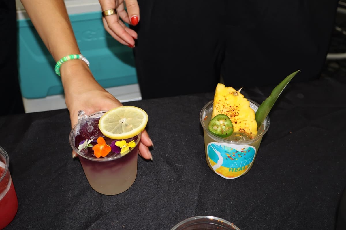 Purple and pineapple garnished mocktail pair at Art Heals event