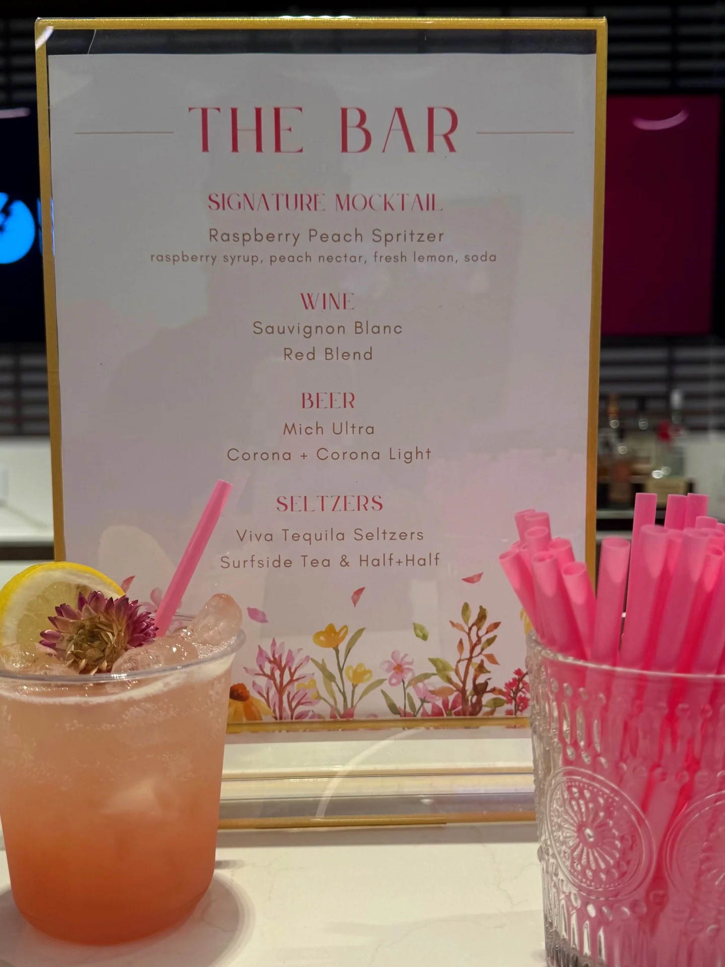 The Bar menu sign with a raspberry peach spritzer signature mocktail