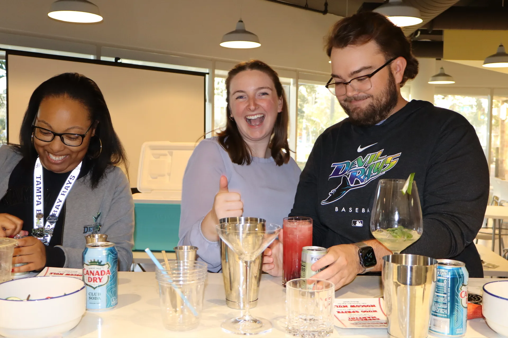 Two TB Mixology bartenders drinking hugo spritz cocktails at end of class