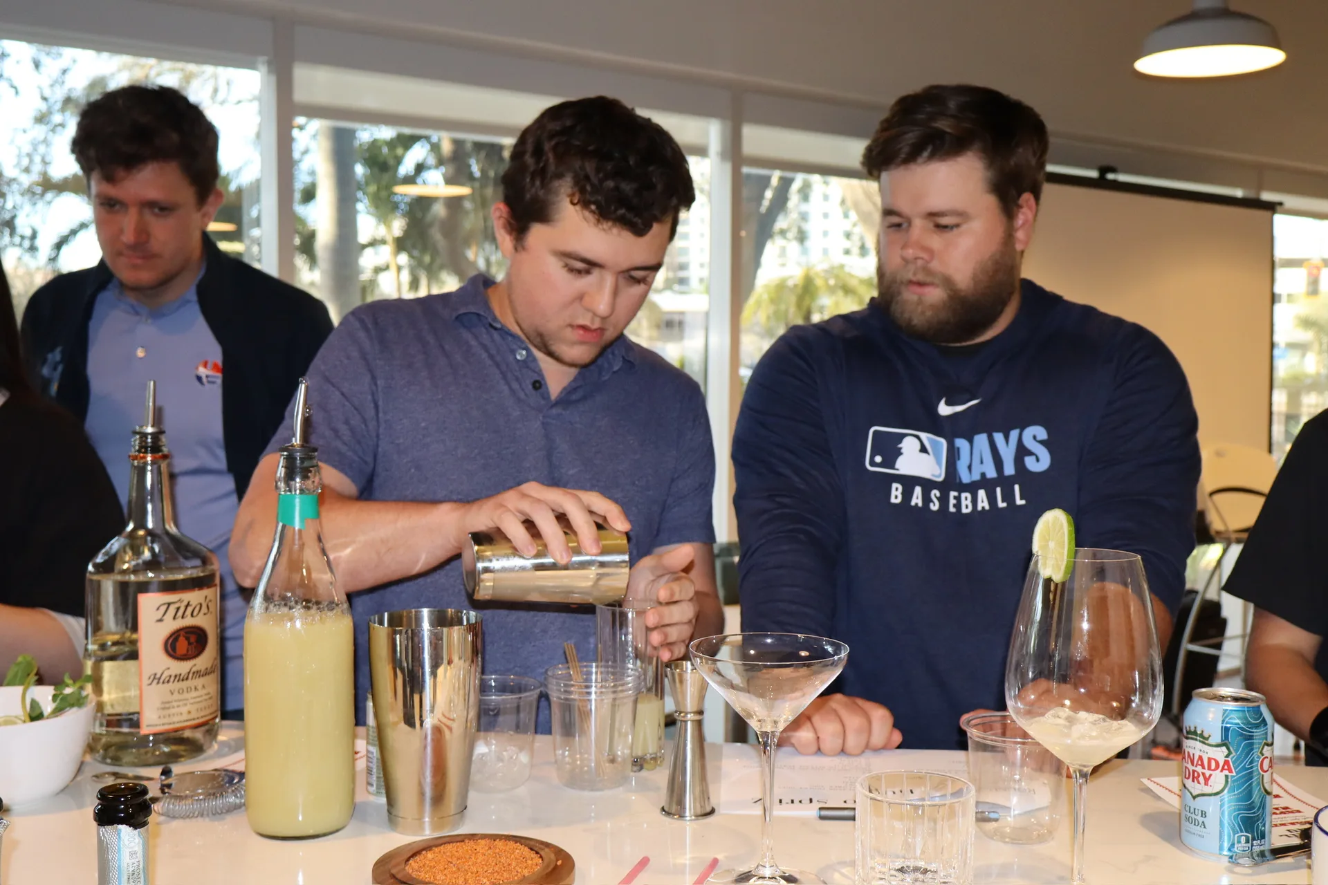 Two women pouring cocktails together at Rays cocktail class