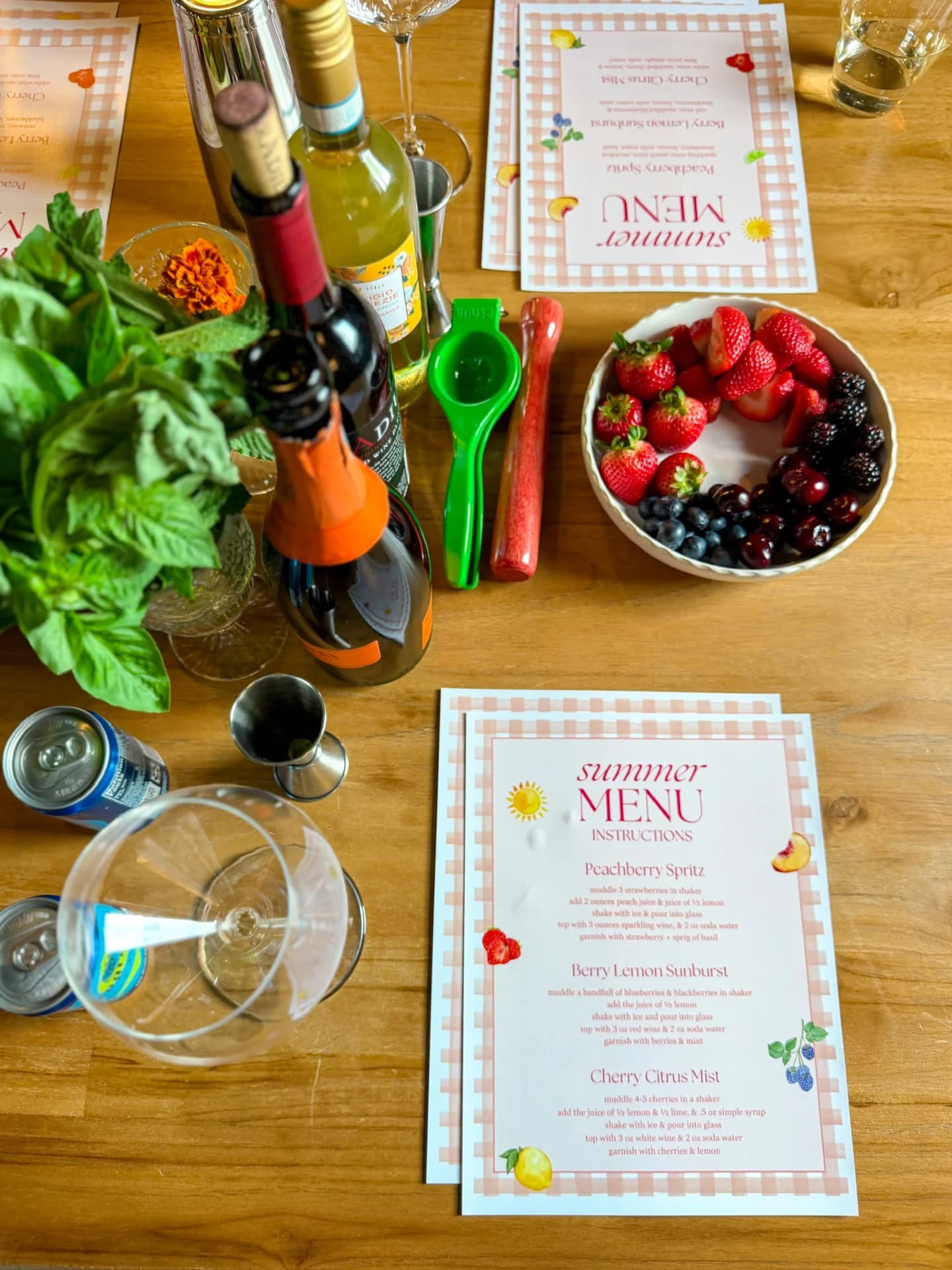 Cocktail kit flat lay with recipe instruction cards, berries, and bar tools