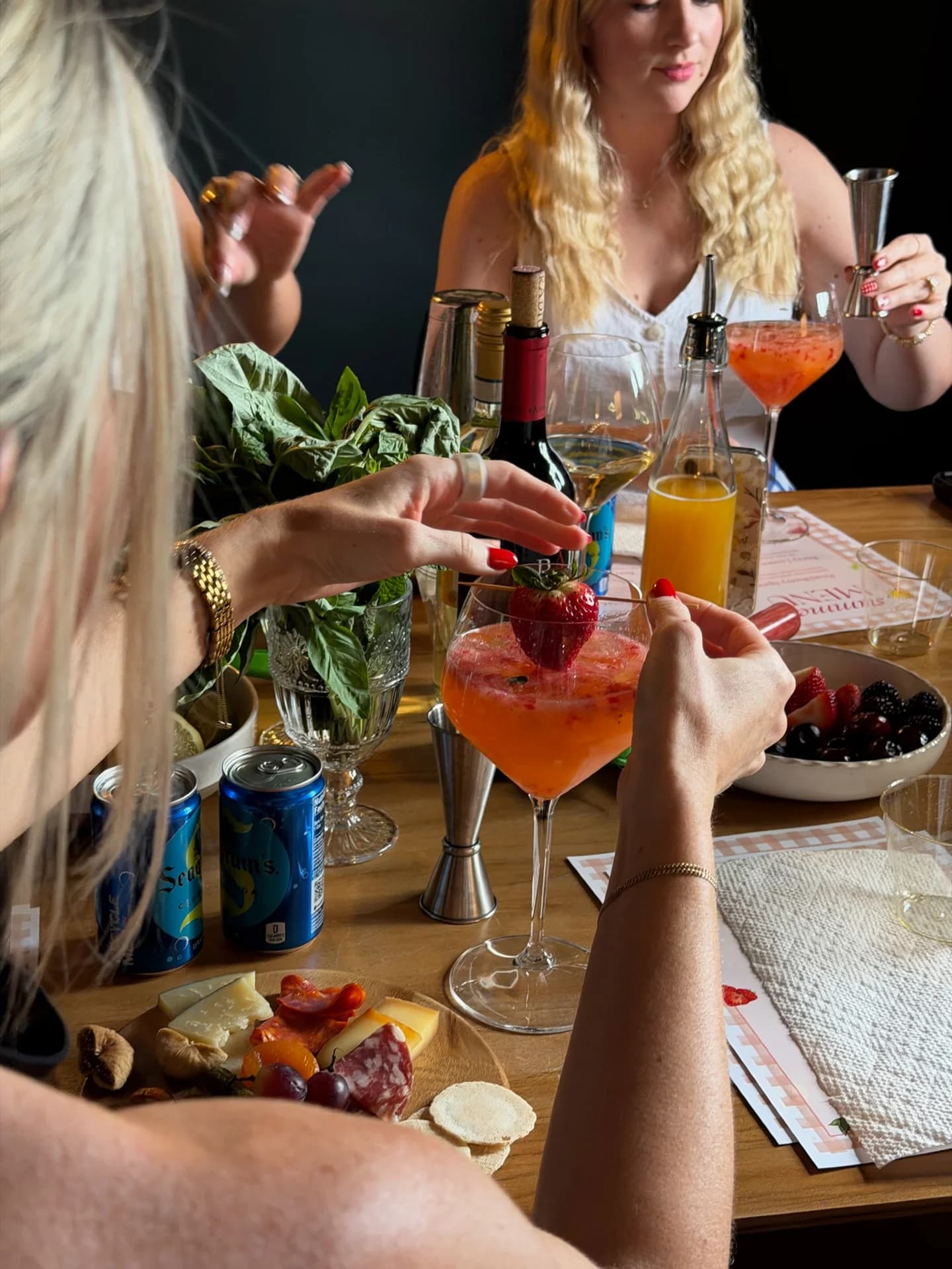Guests crafting strawberry cocktails together at a hosted cocktail class