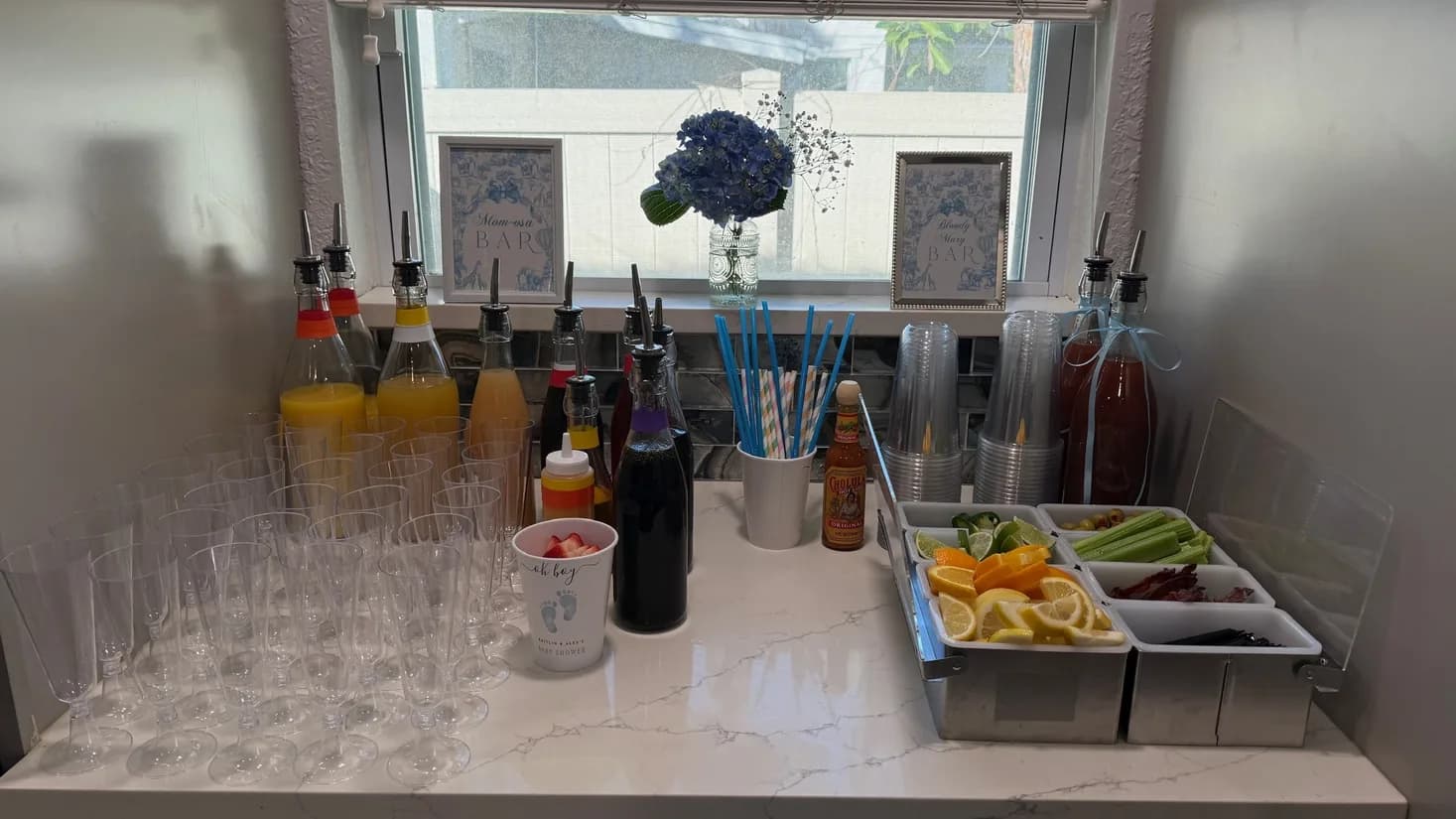 Batch cocktail bar setup with fresh juices, bottles, and garnishes ready to serve
