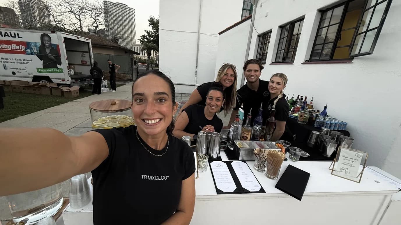 TB Mixology team selfie behind the outdoor bar setup